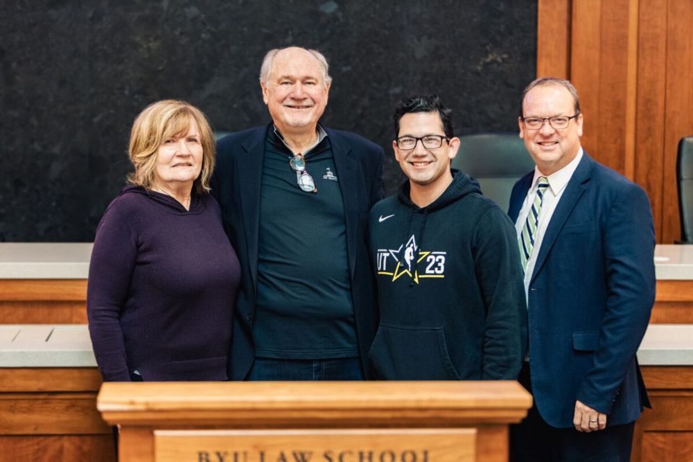 Inaugural James and Susan Parkinson Trial Advocacy Endowed Scholarship recipient, Jehicob Torres, poses for a photo with the Parkinsons (left) and Dean David Moore (right).